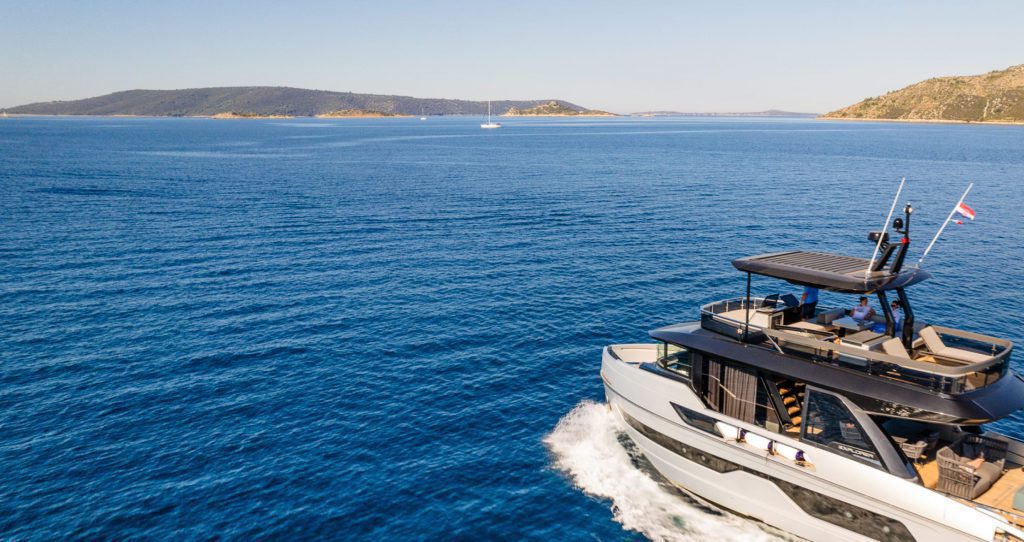 View of a boat on a blue body of water, with islands in the distance